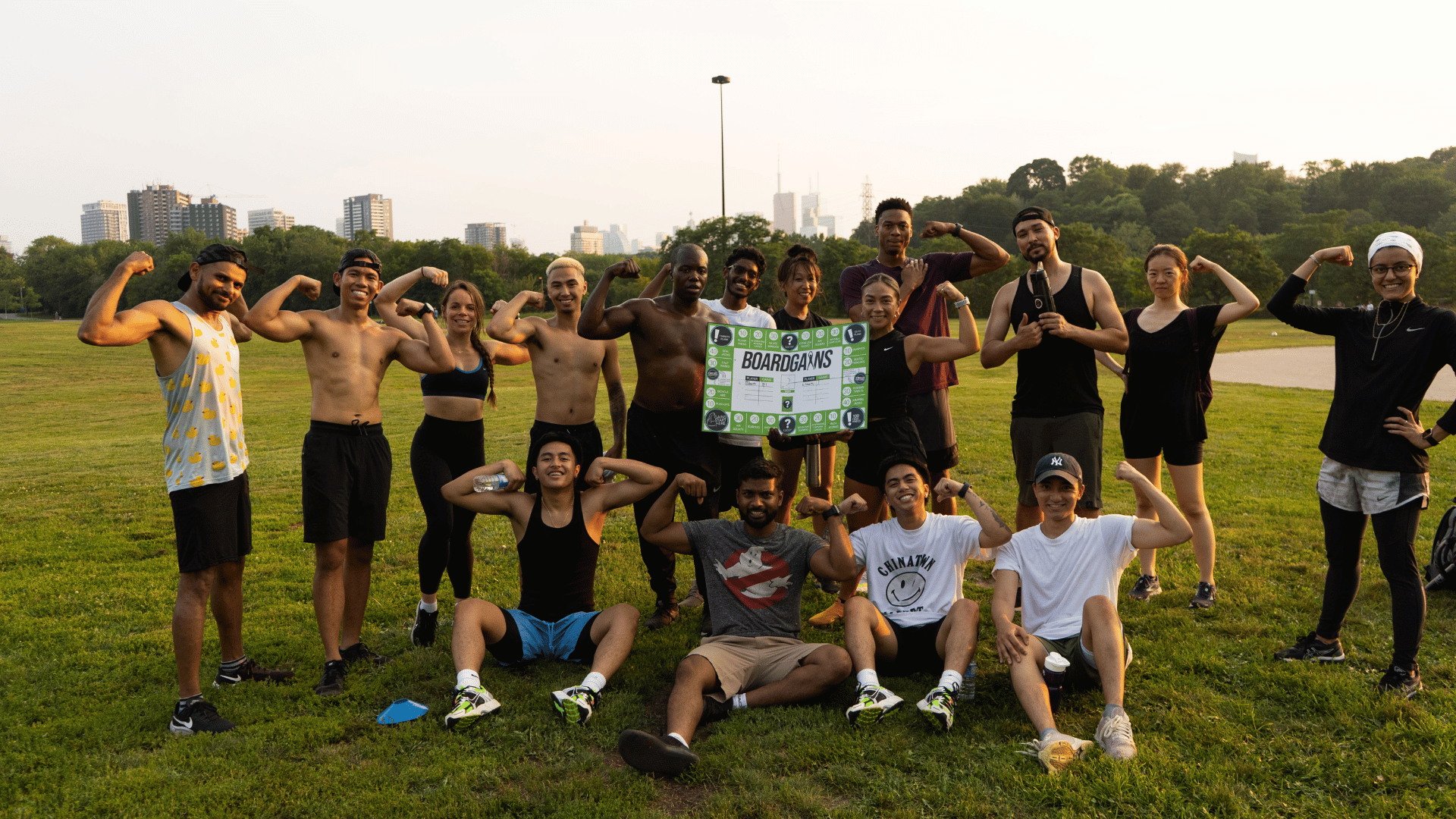 Group of Adults Flexing After Outdoor Boardgains Workout - Celebrating Fitness Achievements