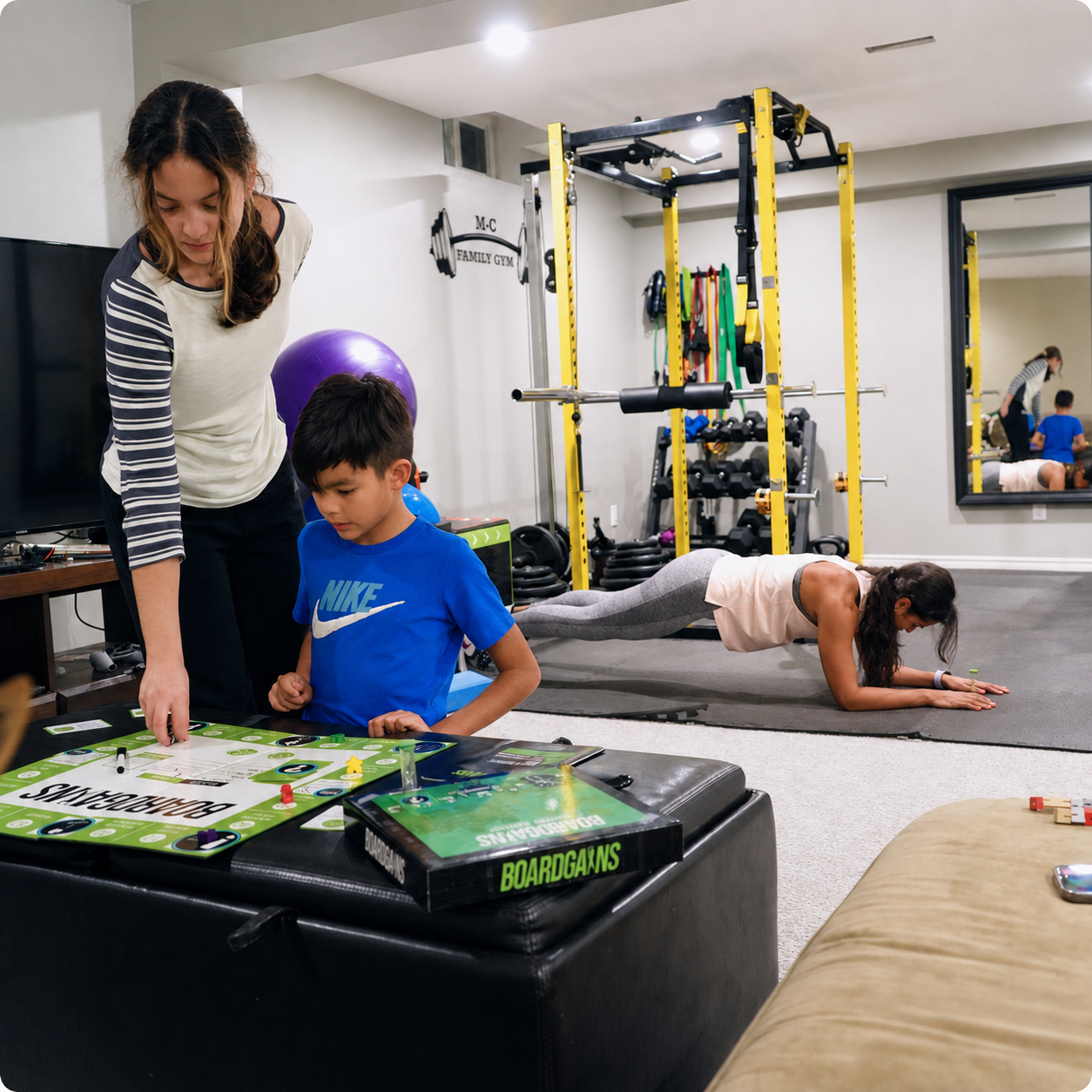 A family fitness scene in a home gym with a woman, a boy, and another woman exercising. In the foreground, a boy in a blue Nike shirt stands at a table with board games, while a woman in a pink tank top does a plank on a mat in the background near yellow gym equipment.