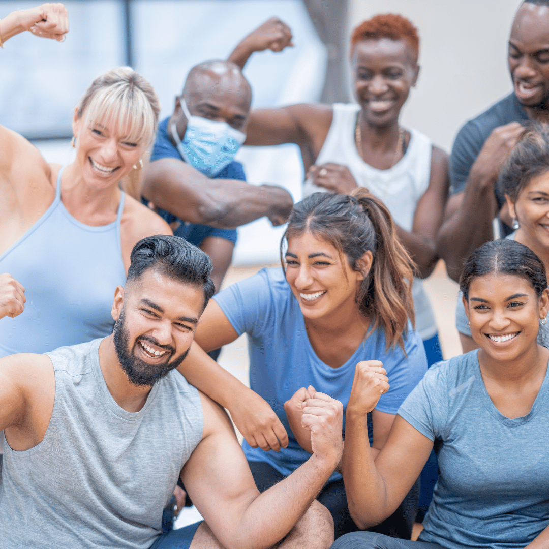 A diverse group of energetic participants enjoying a lively group fitness class, working together to achieve their fitness goals with smiles and determination.