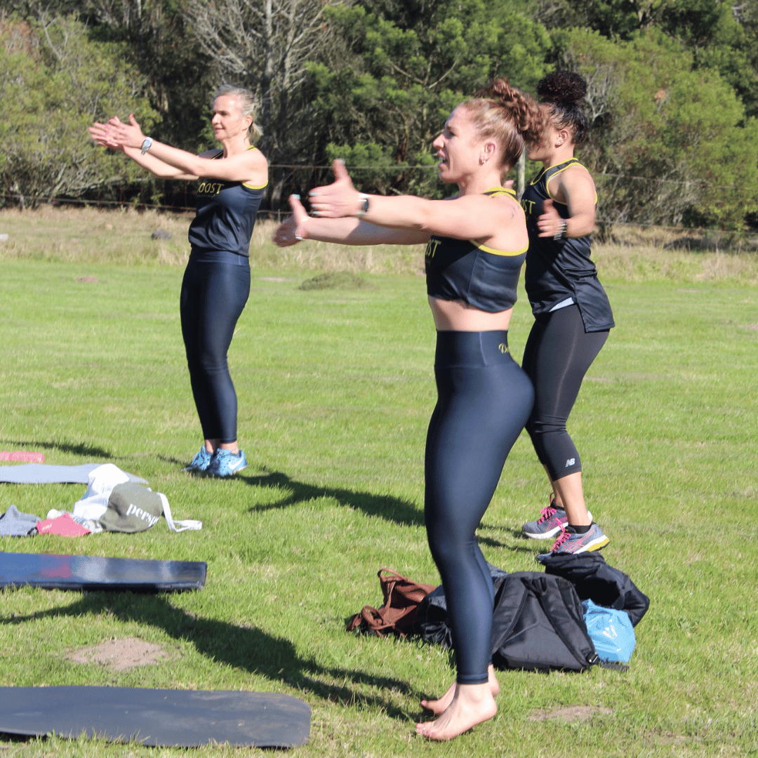 Group of fitness enthusiasts performing Seal Jacks exercise in the outdoor setting
