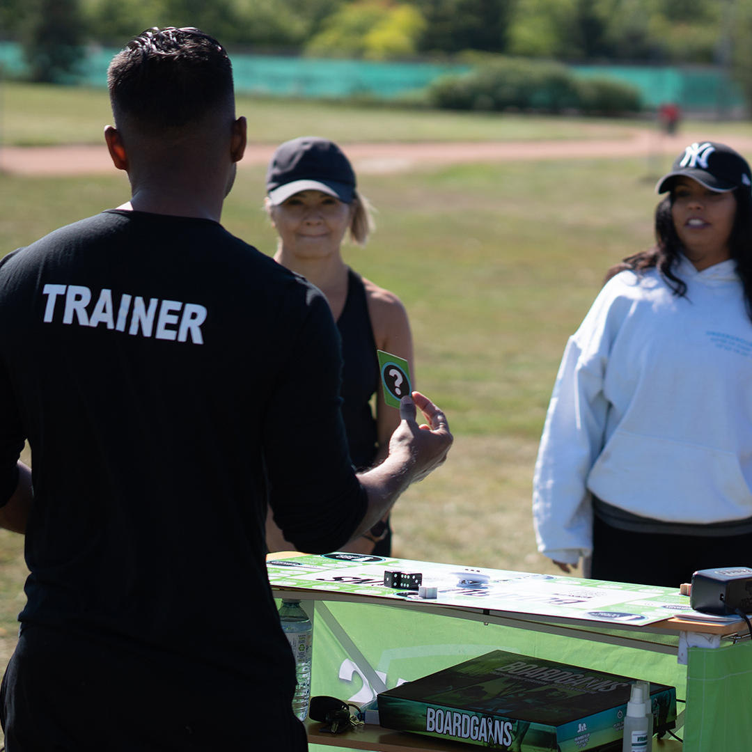 Fitness trainer incorporating the use of Boardgains fitness board game to make group fitness class more interactive and engaging, promoting a fun way to achieve fitness goals.