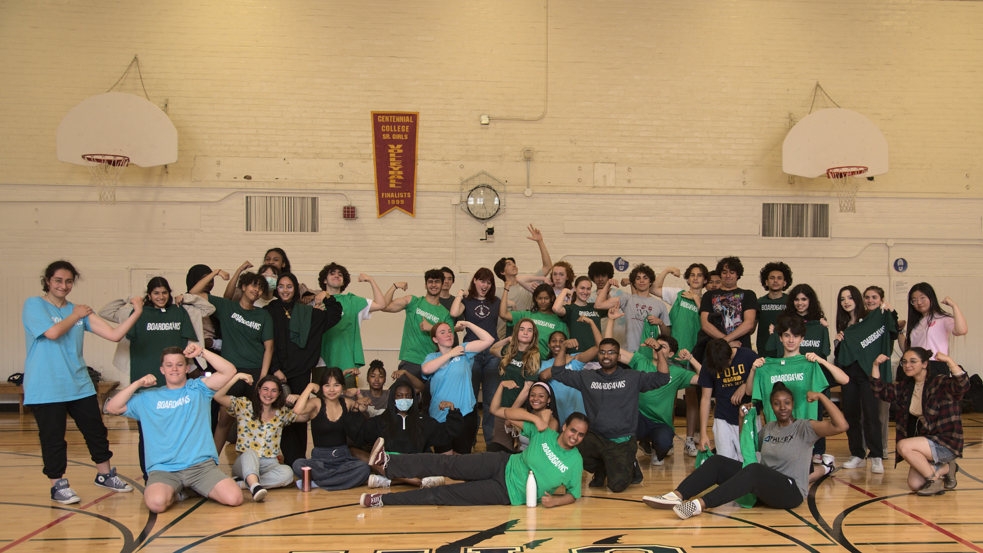 Group Photo of students flexing in a school gym after a boardgains workout